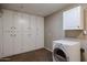 Laundry room with washer, dryer, cabinets, and ample storage at 10220 W White Mountain Rd, Sun City, AZ 85351