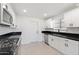 Updated kitchen with black countertops and white cabinets at 2031 E Don Carlos Ave, Tempe, AZ 85281