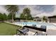 Resort-style pool with a water feature, covered patio, and fire pit at 5704 N Wilkinson Rd, Paradise Valley, AZ 85253