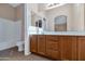 Double vanity bathroom with wood cabinets and large mirror at 17365 N Cave Creek Rd # 116, Phoenix, AZ 85032