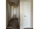 Hallway with carpet and doors to bedrooms and bath at 16013 S Desert Foothills Pkwy # 2112, Phoenix, AZ 85048