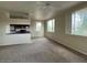 Spacious living room with carpeted floors and a fireplace at 16013 S Desert Foothills Pkwy # 2112, Phoenix, AZ 85048