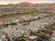Aerial view of a new community with houses, a park, and mountain views at 19834 W Rancho Dr, Litchfield Park, AZ 85340