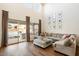 Bright living room with L-shaped sectional sofa and backyard access at 19834 W Rancho Dr, Litchfield Park, AZ 85340