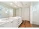 Bathroom with double vanity, large mirror, and walk-in shower at 19834 W Rancho Dr, Litchfield Park, AZ 85340