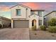 Two-story house with gray garage door and landscaping at 19834 W Rancho Dr, Litchfield Park, AZ 85340