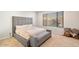 Spacious main bedroom with large bed, plush carpet, and window seat at 19834 W Rancho Dr, Litchfield Park, AZ 85340