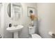 Small powder room with pedestal sink and toilet at 19834 W Rancho Dr, Litchfield Park, AZ 85340