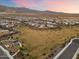 Aerial view of a residential area with a park and playground near mountains at 19834 W Rancho Dr, Litchfield Park, AZ 85340