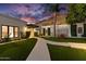 Evening view of home's exterior, showcasing landscaping and architectural details at 6432 E El Sendero Rd, Carefree, AZ 85377