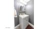 Small bathroom with gray walls, white vanity, and a framed mirror at 4610 N 68Th St # 414, Scottsdale, AZ 85251