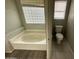 Bathroom with bathtub and toilet, featuring updated tile at 1458 E Black Diamond Dr, Gilbert, AZ 85296