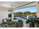 Covered patio with comfortable seating overlooking the pool at 20594 W Pasadena Ave, Buckeye, AZ 85396