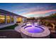Circular spa with built-in fire feature next to pool at 20594 W Pasadena Ave, Buckeye, AZ 85396