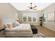 Bright bedroom with ceiling fan, neutral decor, and natural light at 20594 W Pasadena Ave, Buckeye, AZ 85396