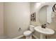 Powder room with pedestal sink, toilet and modern decor at 20594 W Pasadena Ave, Buckeye, AZ 85396
