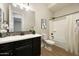 Bathroom with dark vanity, tub shower combo, and tile flooring at 20594 W Pasadena Ave, Buckeye, AZ 85396