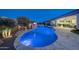 Stunning pool and spa at dusk with landscape lighting at 20594 W Pasadena Ave, Buckeye, AZ 85396