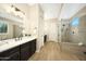 Elegant bathroom with double vanity, large shower, and neutral tile at 20594 W Pasadena Ave, Buckeye, AZ 85396