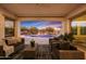 Covered patio with comfortable seating overlooking the pool at 20594 W Pasadena Ave, Buckeye, AZ 85396