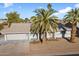 Single story home with a two-car garage and spacious front yard at 10452 W Meade Dr, Sun City, AZ 85351