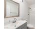 Modern bathroom with gray vanity, shower, and framed mirror at 10452 W Meade Dr, Sun City, AZ 85351