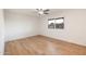 Bedroom with wood-look floors, ceiling fan and backyard view at 10452 W Meade Dr, Sun City, AZ 85351