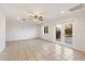 Bright bedroom with tile floors, ceiling fan, and patio access at 10452 W Meade Dr, Sun City, AZ 85351