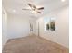 Spacious bedroom with carpeted floors and ceiling fan at 10452 W Meade Dr, Sun City, AZ 85351