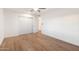 Light and airy bedroom with wood-look floors and ceiling fan at 10452 W Meade Dr, Sun City, AZ 85351