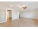 Bedroom with tile floors, ceiling fan and access to another room at 10452 W Meade Dr, Sun City, AZ 85351