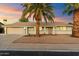 Single-story home with neutral exterior, attached garage, and palm trees at 10452 W Meade Dr, Sun City, AZ 85351
