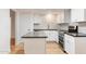 Modern kitchen with white cabinets, gray countertops, and white subway tile backsplash at 10452 W Meade Dr, Sun City, AZ 85351