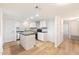 Bright kitchen features white shaker cabinets, gray countertops, and an island at 10452 W Meade Dr, Sun City, AZ 85351