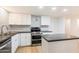 Modern kitchen with white shaker cabinets and dark countertops at 10452 W Meade Dr, Sun City, AZ 85351