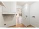 Laundry room with built-in cabinets and access to backyard at 10452 W Meade Dr, Sun City, AZ 85351