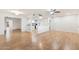 Open living area with light wood floors, a view into kitchen at 10452 W Meade Dr, Sun City, AZ 85351