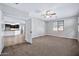 Bright bedroom with neutral carpeting and ceiling fan at 16002 W Jenan Dr, Surprise, AZ 85379