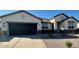 Single-story home with a two-car garage and desert landscaping at 25588 N 154Th Ln, Surprise, AZ 85387