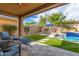 Landscaped backyard oasis with a pool, fireplace, and covered patio at 4526 E Vista Bonita Dr, Phoenix, AZ 85050