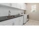 Laundry room with white cabinets, granite countertops, and a window at 4526 E Vista Bonita Dr, Phoenix, AZ 85050