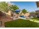 Relaxing pool area with a built-in fire pit and ample seating at 4526 E Vista Bonita Dr, Phoenix, AZ 85050