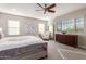 Main bedroom with king-size bed, armchair, and large dresser at 4526 E Vista Bonita Dr, Phoenix, AZ 85050