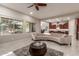 Open living room with curved sofa and views into the kitchen area at 4526 E Vista Bonita Dr, Phoenix, AZ 85050