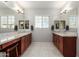 Double vanity bathroom with granite countertops and large mirrors at 4526 E Vista Bonita Dr, Phoenix, AZ 85050