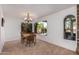 Bright dining room with a wooden table and chairs, offering a view of the backyard at 2253 S El Marino --, Mesa, AZ 85202