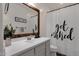 Clean bathroom with gray vanity, a large mirror, and a shower/tub combo at 357 W Haxtun St, San Tan Valley, AZ 85143