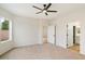 Spacious bedroom with plush carpeting, ceiling fan, and access to bathroom at 10802 E Secret Canyon Rd, Gold Canyon, AZ 85118