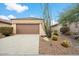 Single-story home with brown garage door and desert landscaping at 10802 E Secret Canyon Rd, Gold Canyon, AZ 85118