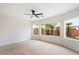 Bright bedroom with carpeted floor, ceiling fan, and large window offering natural light at 10802 E Secret Canyon Rd, Gold Canyon, AZ 85118